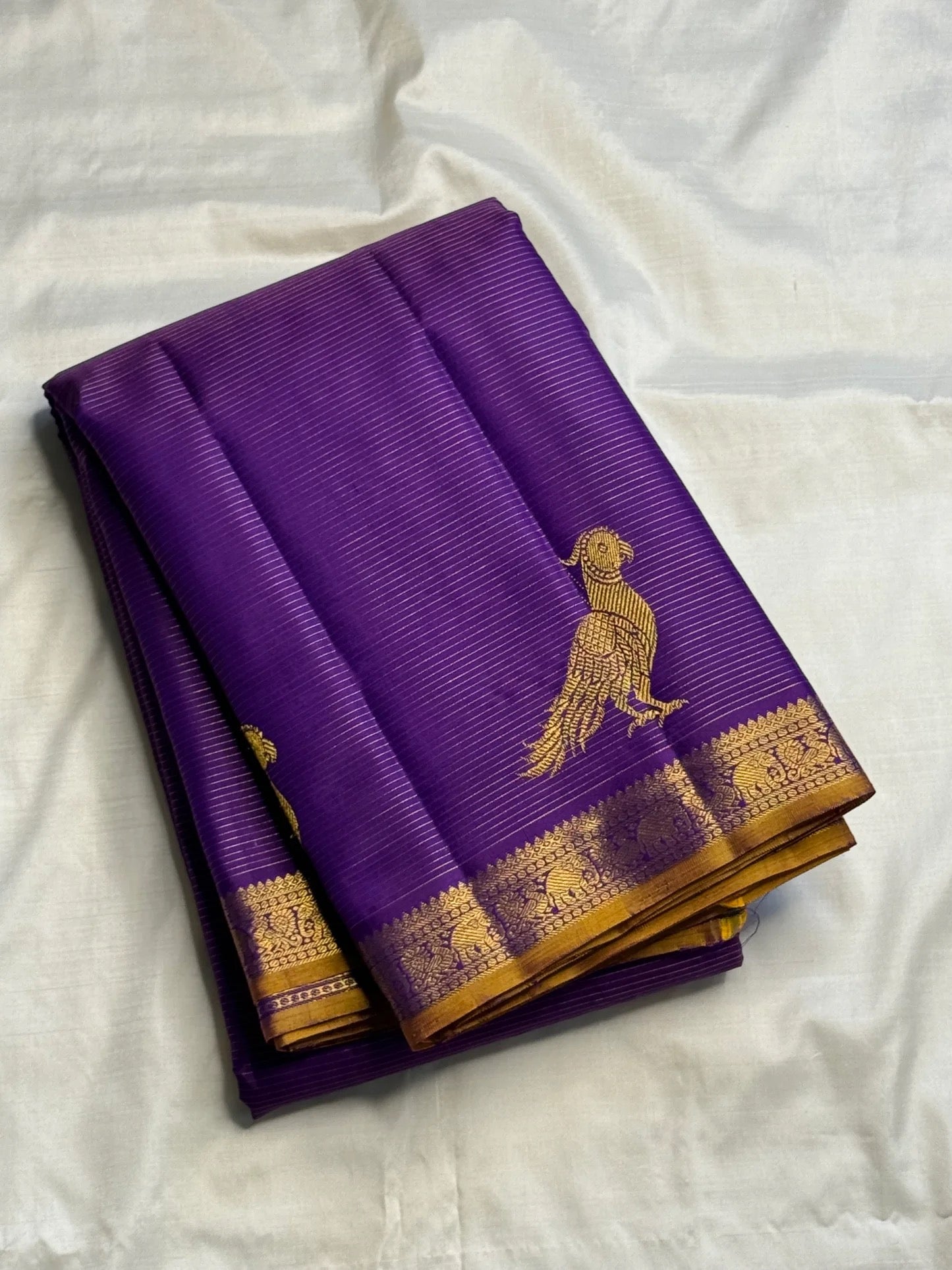 Handwoven purple Vairaoosi saree with traditional antique-gold ornamental zari border.
