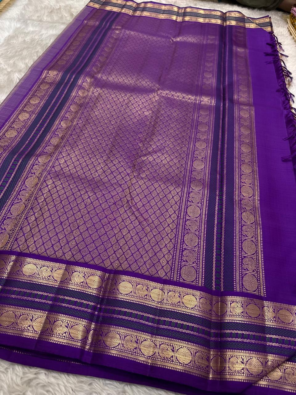 Warm beige pure silk Kanchipuram saree with regal violet korvai border – drape view
