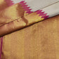 Warm Ivory pure silk Kanjivaram Ettukol saree with Rani Pink temple edge and antique-gold zari border.