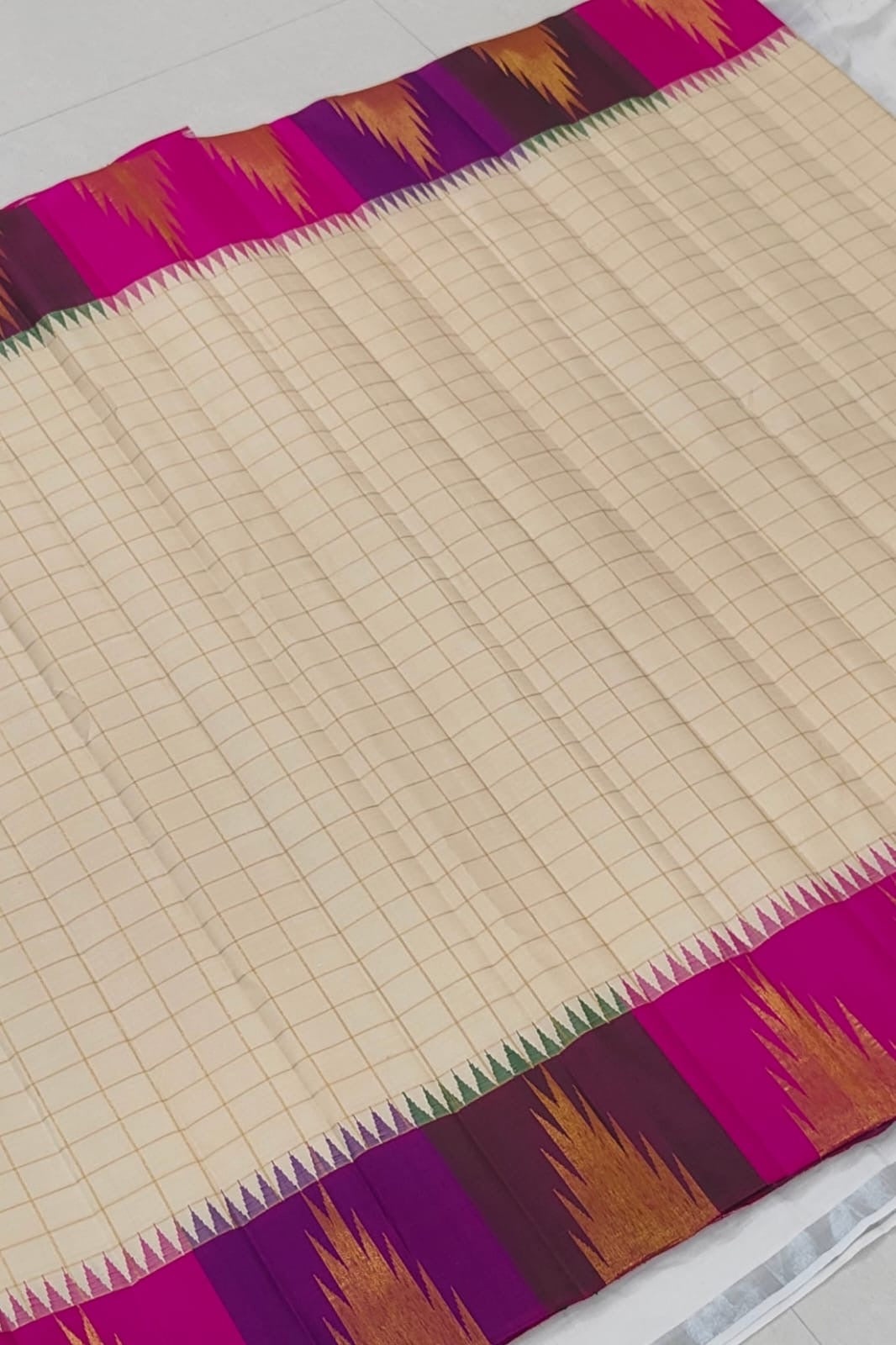 Warm Ivory Ettukol Kanchipuram silk body woven with fine gold checks and a vivid multicolour border.