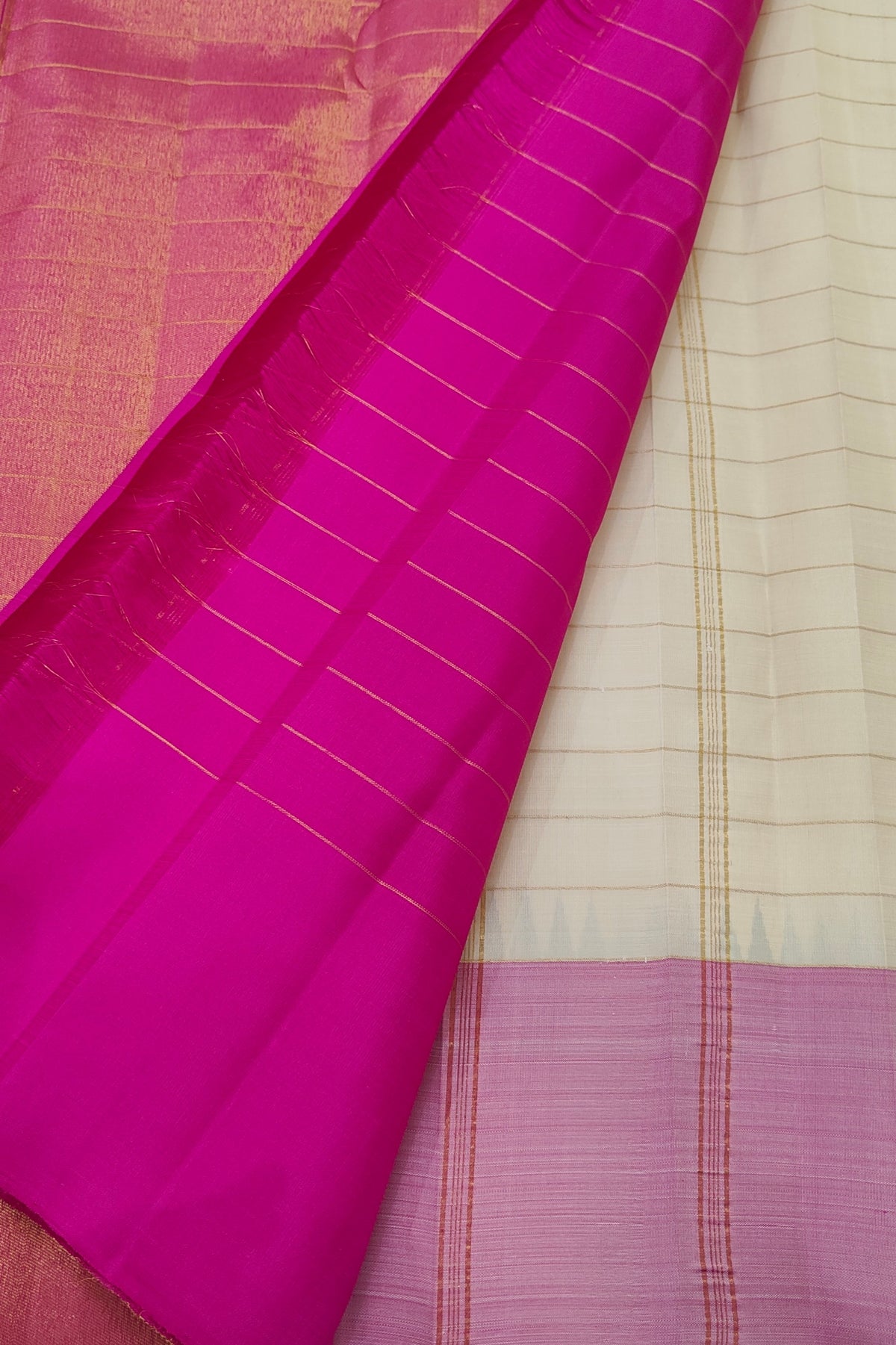 Handwoven Warm Ivory Kanjipuram saree with magenta, purple and aubergine Ettukol border.