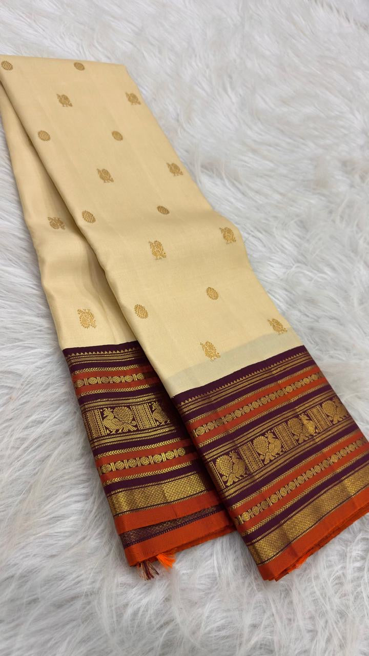 Close view of Deep Aubergine Purple and Burnt Orange Varisaipet border on Warm Ivory pure silk.