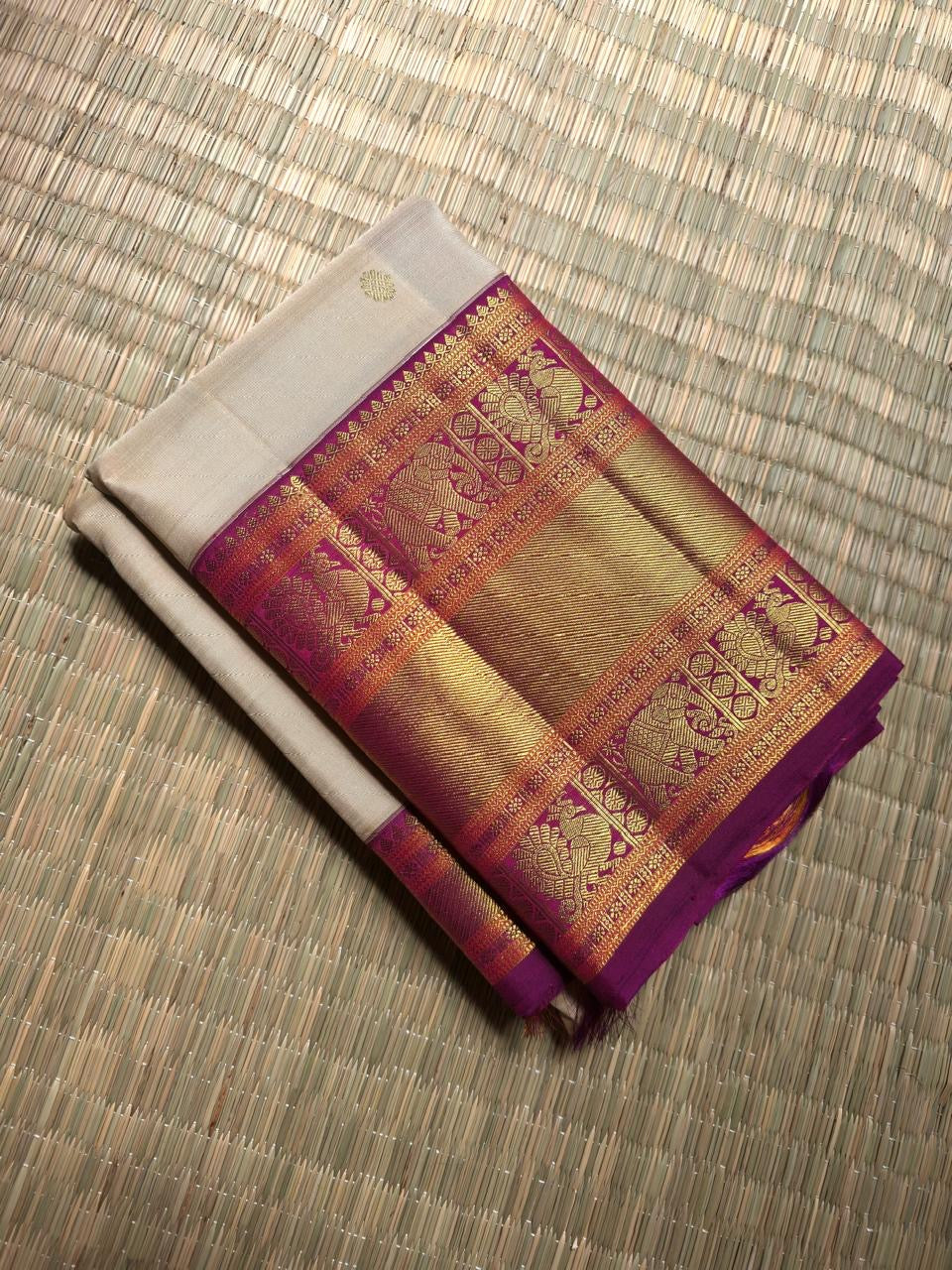 Warm Ivory Kanchipuram saree with Vadamalli Purple Yaanai border detail