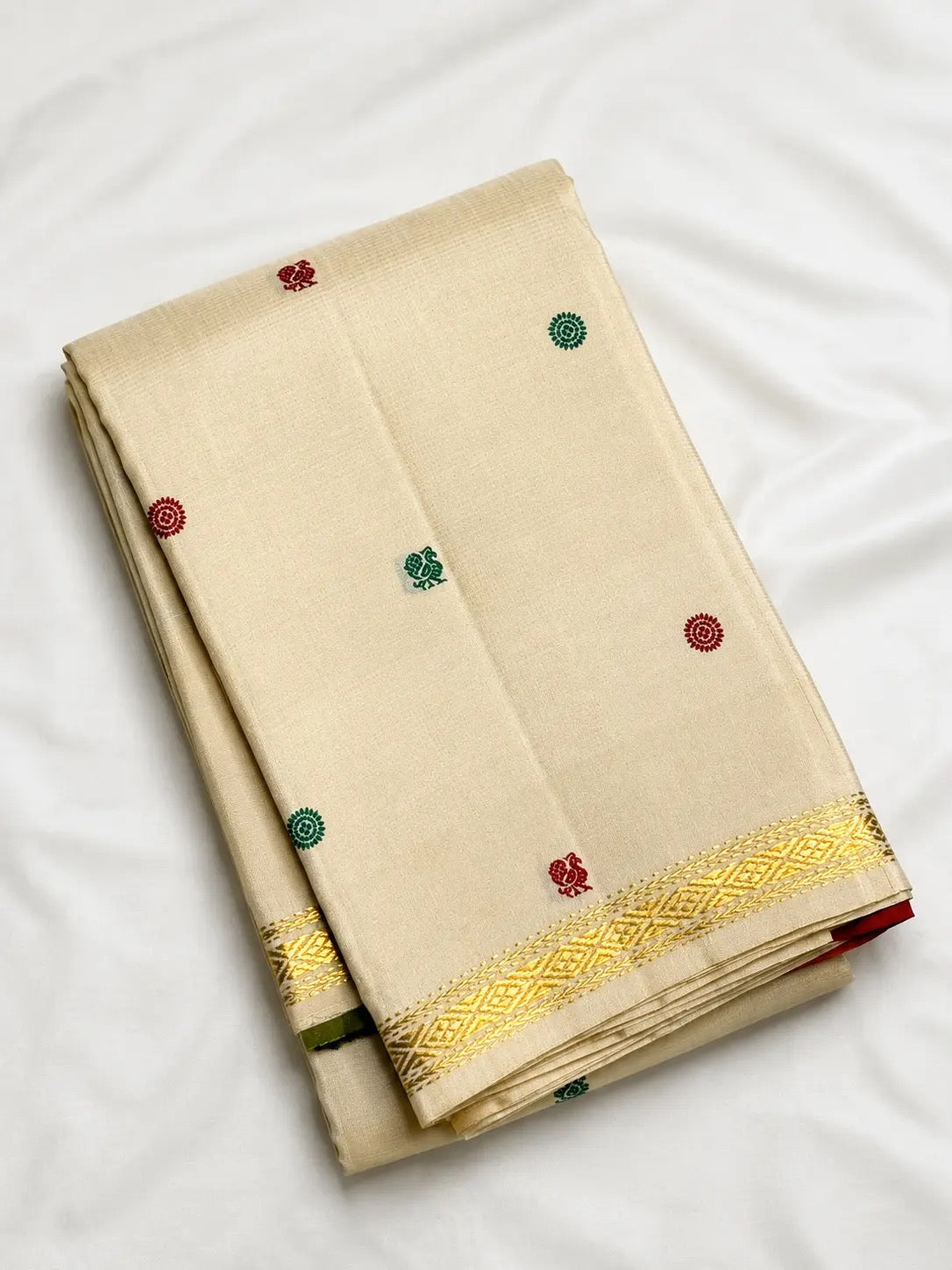 Warm Ivory silk saree with narrow geometric gold zari border.