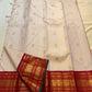 Handwoven gold zari buttas on a Warm Sandalwood Ivory silk saree.
