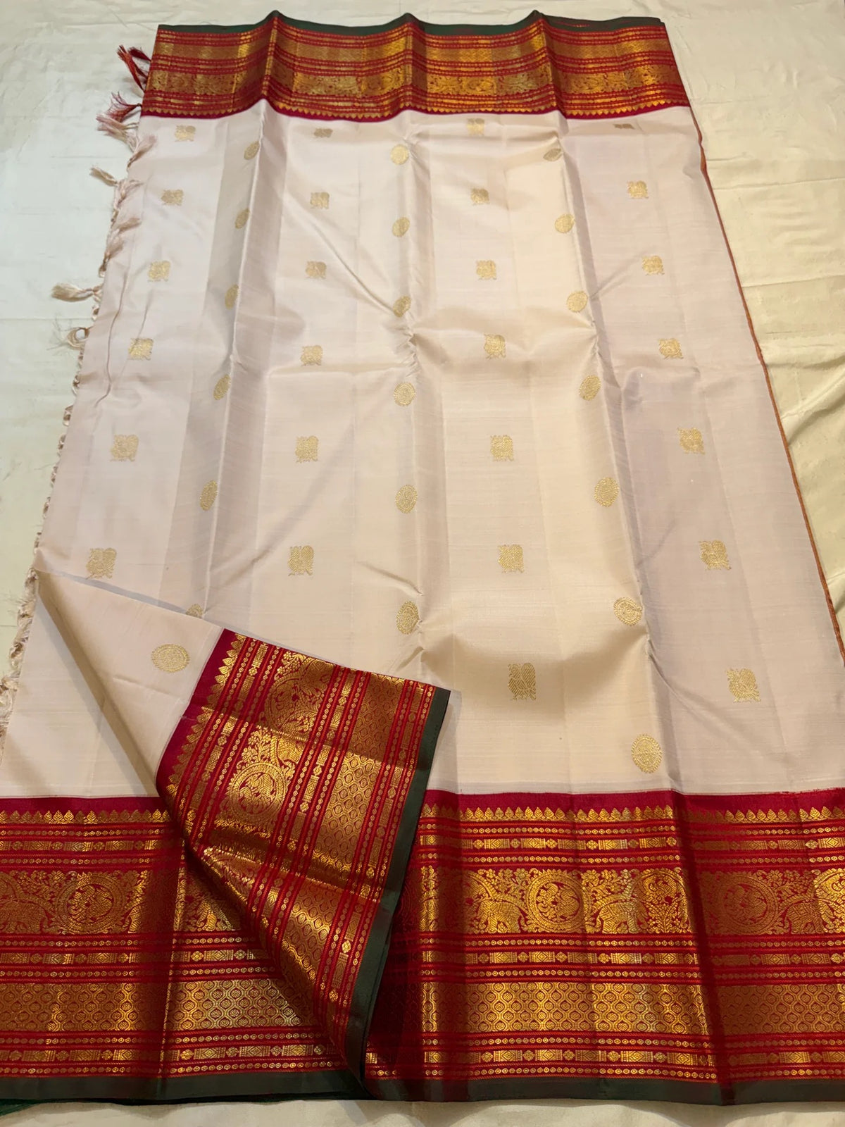 Handwoven gold zari buttas on a Warm Sandalwood Ivory silk saree.