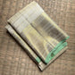 Warm Ivory Zari Kattam silk showing fine checked lines, petite Kamalam buttas and broad metallic zari border.