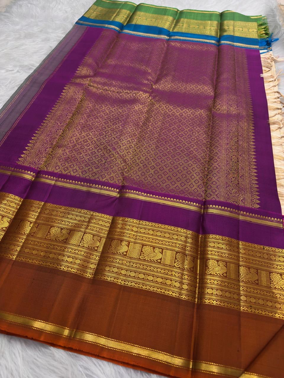 Warm Ivory VarnaJaalam Kanchipuram silk with varied horizontal gold zari motif stripes and multicolour contrast border.