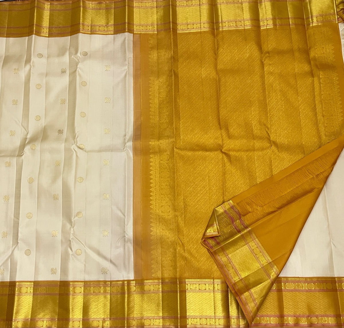 Warm Ivory Handwoven Pure Silk Kanchipuram Saree with Bavanji Border and Mayil Chakram, woven motif and zari detail