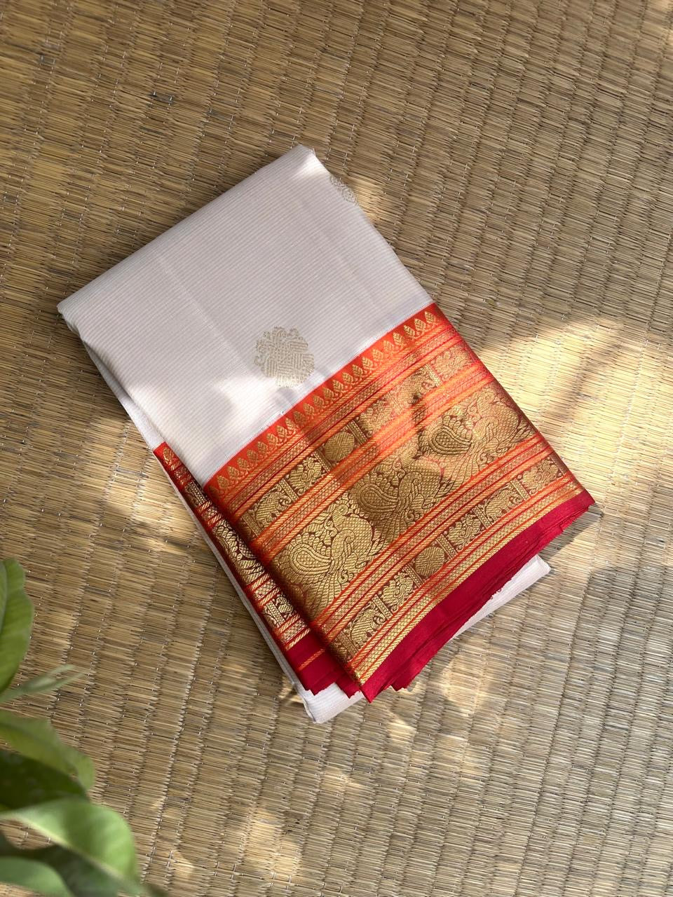 Warm Ivory Kanchipuram Saree — raspberry-magenta Korvai border with gold zari peacocks and floral vines