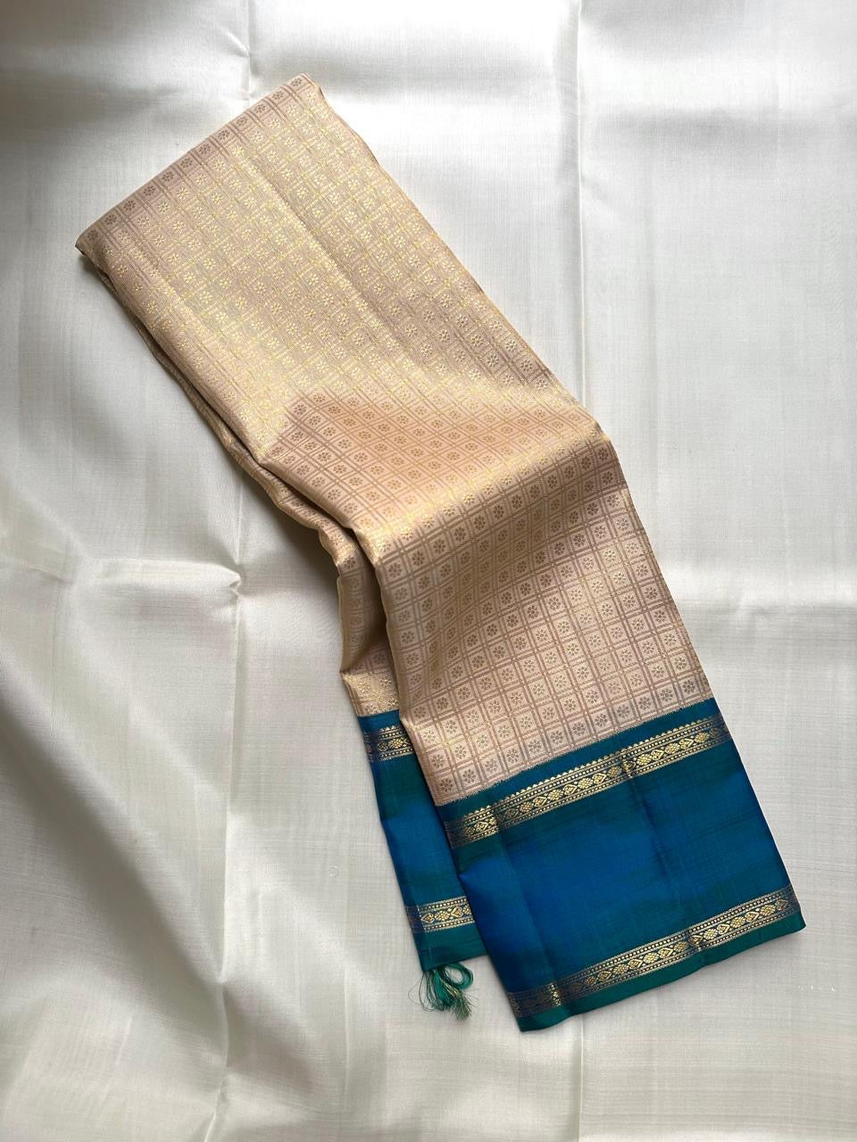 Warm Ivory Handwoven Pure Silk Kanjivaram Saree with Zari Kattam and Peacock Blue-Green Shot Border