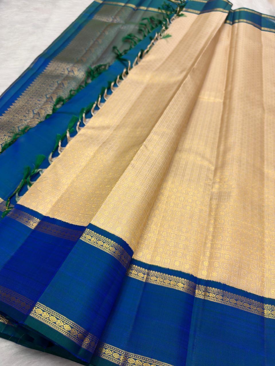 Warm Ivory Handwoven Pure Silk Kanjivaram Saree with Zari Kattam and Peacock Blue-Green Shot Border