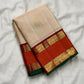 Kanchipuram Korvai saree showing burnt orange border, intricate gold zari bands and forest-green silk edge.