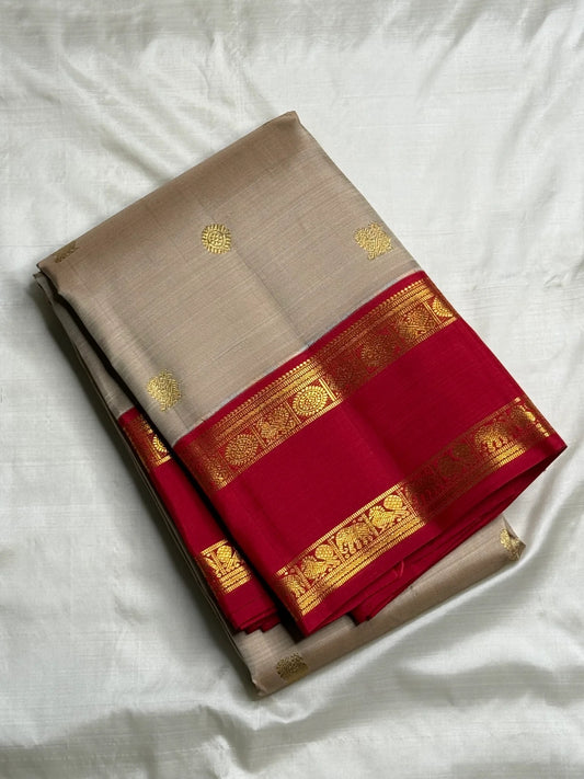 Full open view highlighting the warm ivory body and evenly spaced gold buttas