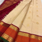 Deep maroon Kanchipuram silk pallu densely woven with traditional repeating gold zari patterns.
