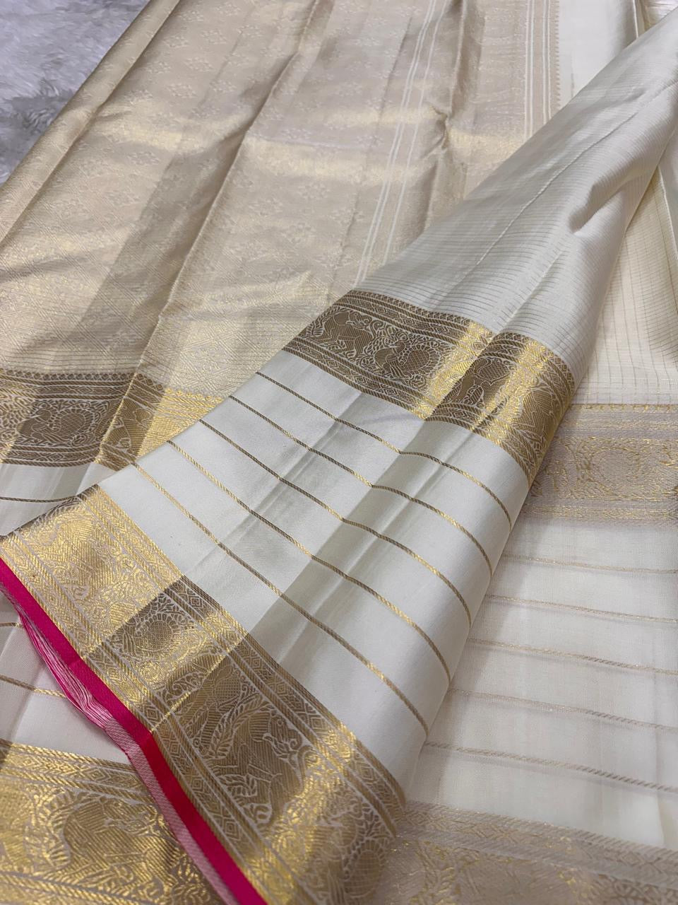 Close view of traditional Mayil zari motifs woven across Warm Ivory Kanjivaram silk.