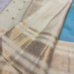 Warm Ivory Kanchipuram silk showing detailed geometric metallic zari border and delicate woven buttas.