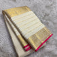 Ivory Kanchipuram silk saree with fine gold checked weaving and spaced zari motifs.