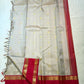 Full laid-flat view of warm ivory saree with gold zari buttas and pink border