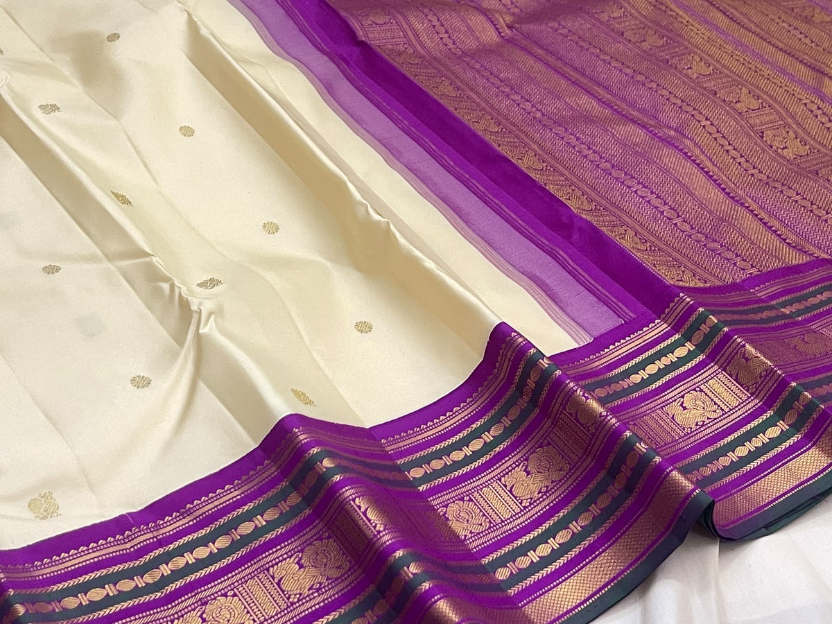 Handwoven ivory Kanchipuram silk saree with 2-gram antique gold zari buttas
