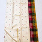 Warm Ivory Kanjeevaram silk body with deep green and raspberry-maroon thread buttas.