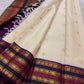 Warm Ivory Kanchipuram silk opened to show petite zari buttas and stacked elephant gold zari border.