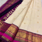 Warm Ivory KanchiPattu silk body with spaced gold zari flower-bunch buttas containing paisley details.