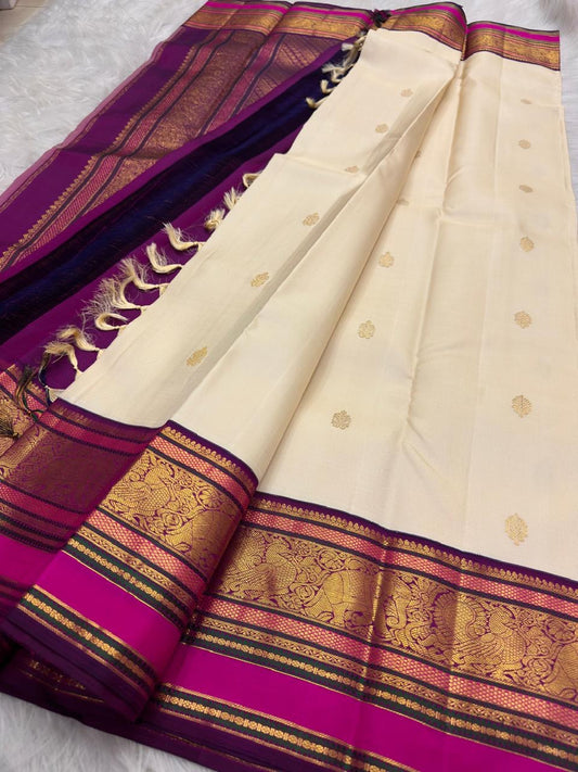 Warm Ivory KanchiPattu silk body with spaced gold zari flower-bunch buttas containing paisley details.
