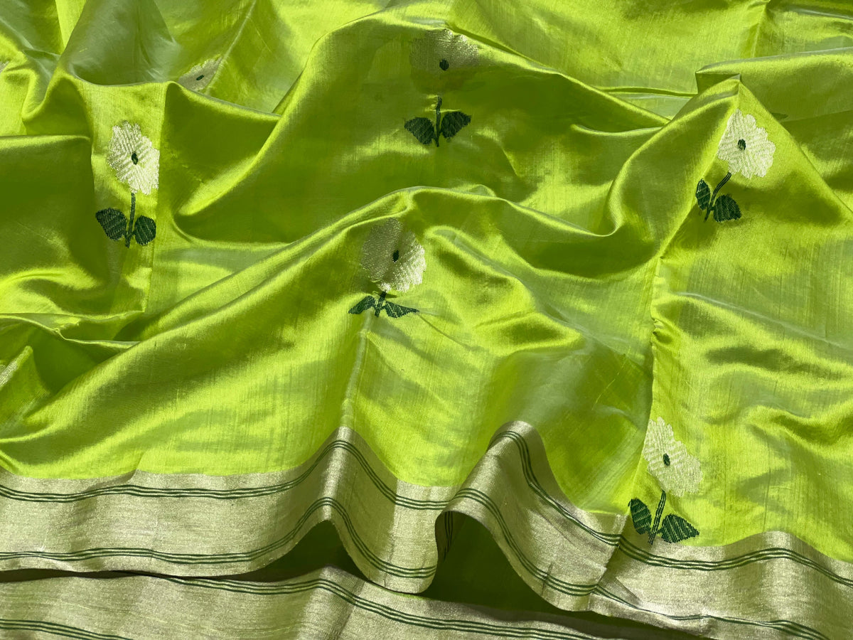 Delicate white flower motif with deep green centre and leaves woven on chartreuse green silk.