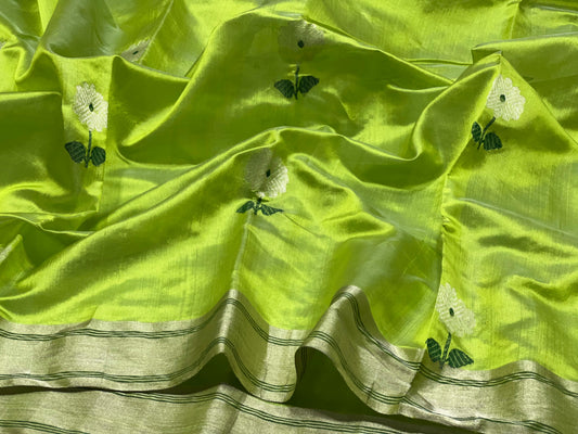 Delicate white flower motif with deep green centre and leaves woven on chartreuse green silk.