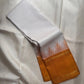 White handwoven Pure Silk Kanchipuram korvai saree folded to show the mustard border