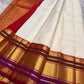 Full view of ivory Pure Kanchipuram silk saree with gold buttas, wide zari border, and a red pallu section with gold zari patterning.