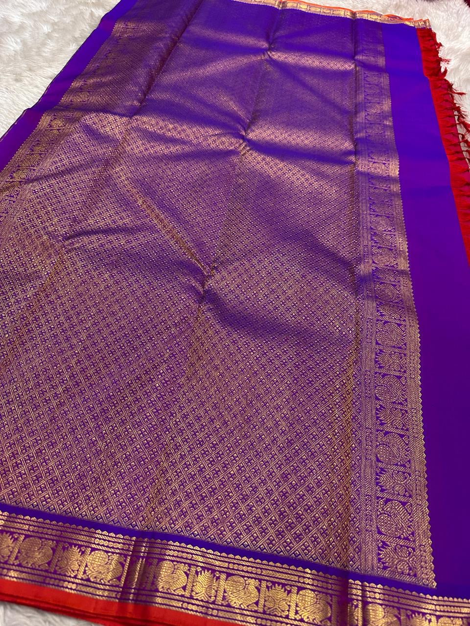 Full pallu spread in royal blue with dense gold zari weave and contrast border; available in the USA.