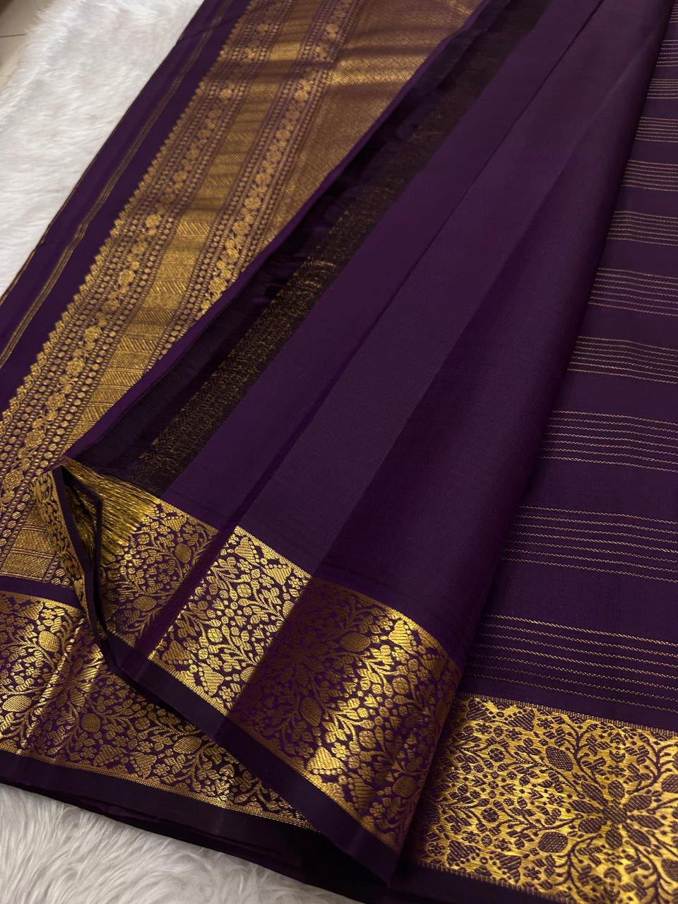 Full pallu of wine purple Kanjeevaram saree with dense floral gold zari border panels — Idam Living