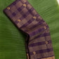 Wine purple Zari Kattam Kanchipuram silk saree rolled showing gold check body with Kili butta and floral border — Idam Living