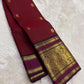 Wine red Kanjeevaram silk saree with traditional gold zari close-up