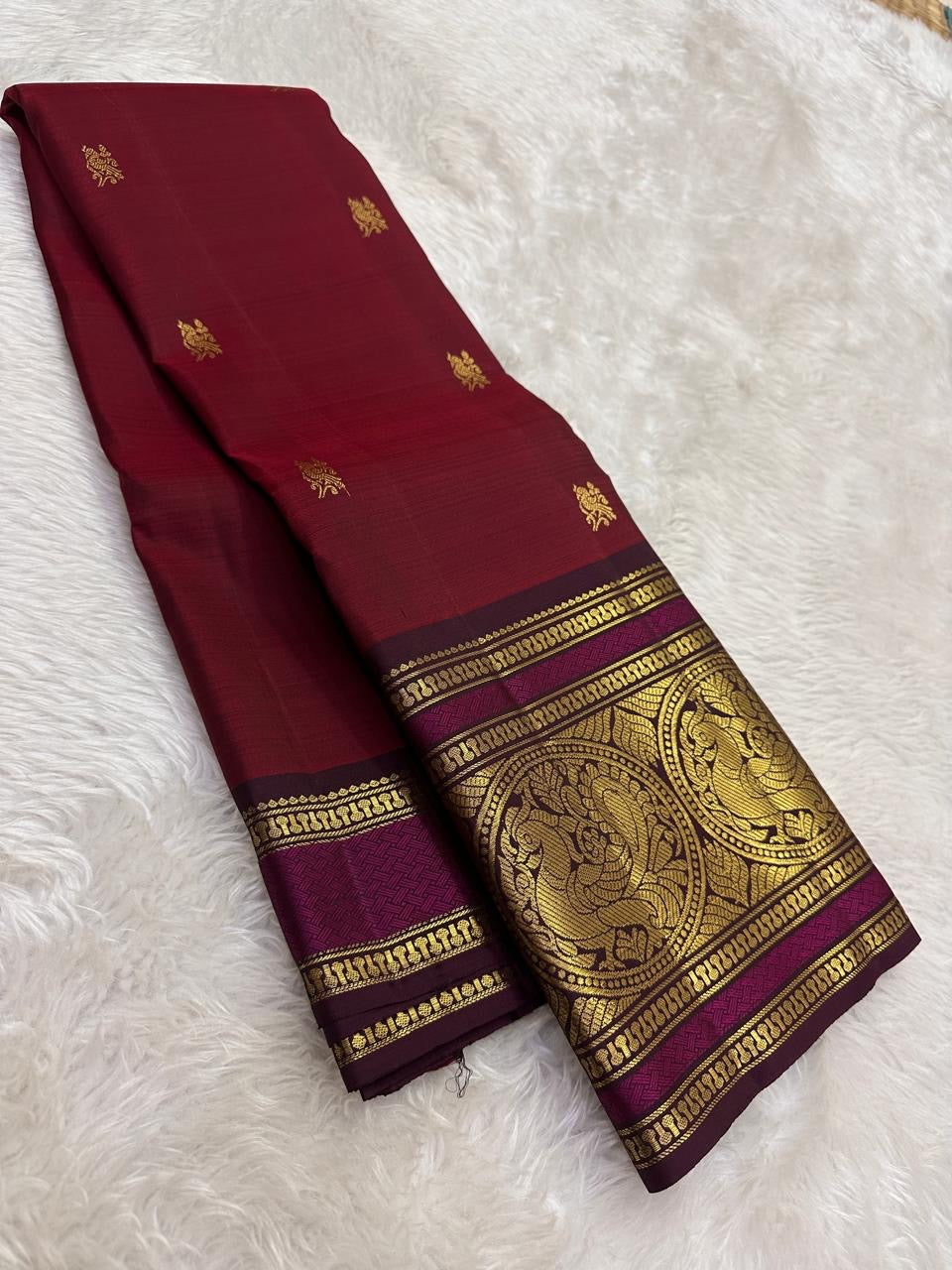Wine red Kanjeevaram silk saree with traditional gold zari close-up