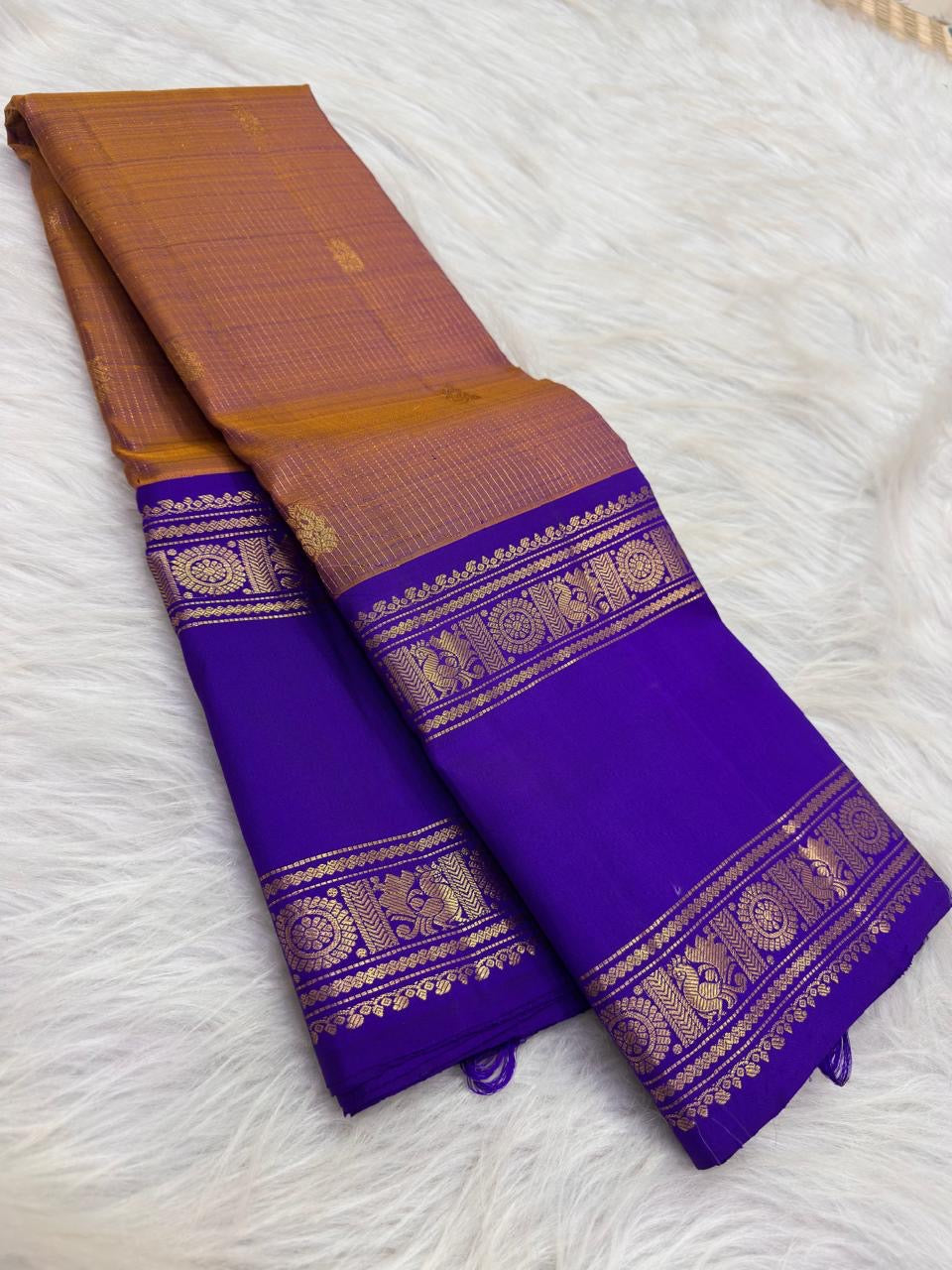 Fine hand-laid gold oosivaanam stripes across sandalwood copper and royal violet silk