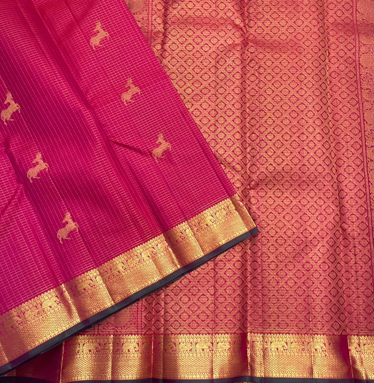 Heritage border with Yaanai pet and Mayil kan pet gold zari detailing on a deep pink Kanjivaram saree