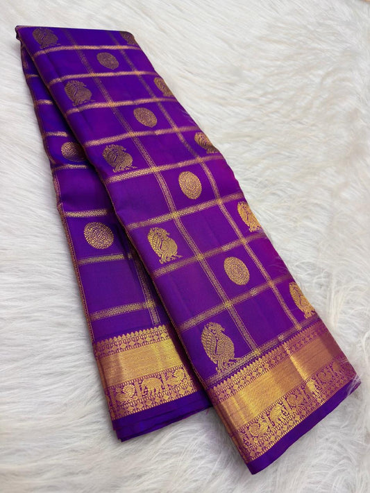 Yaanai gold-zari border on the Kathiripoo Violet Kanchipuram saree.