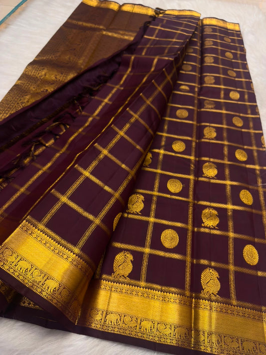 Yaanai gold-zari border on the Naval Pazham Deep Plum Kanchipuram saree.