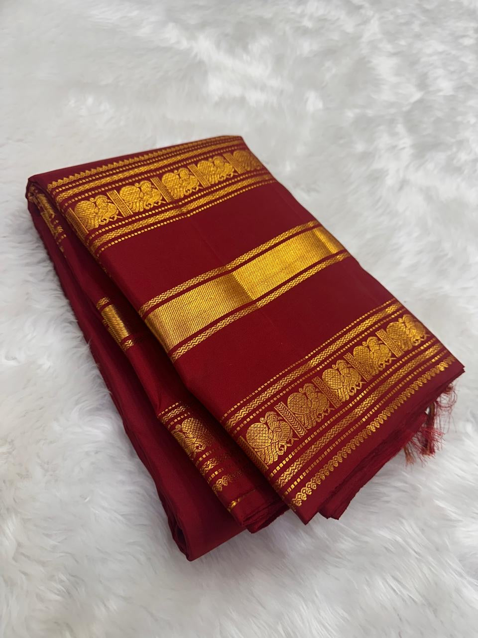 Close-up of the Yaanai gold zari Varisaipet border on the Arakku Red Kanchipuram silk saree by Idam Living