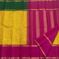 contrast green and magenta zari border detail on sunflower yellow kanchipuram silk saree