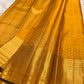 Close view of fine antique-gold zari buttas on Turmeric Yellow Kanjivaram silk.