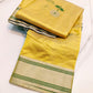 Handloom Turmeric Yellow Chanderi saree with silver floral buttas and green woven leaves