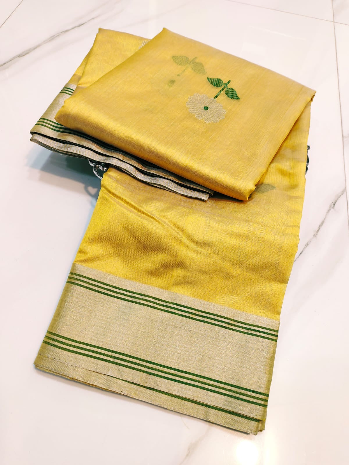 Handloom Turmeric Yellow Chanderi saree with silver floral buttas and green woven leaves