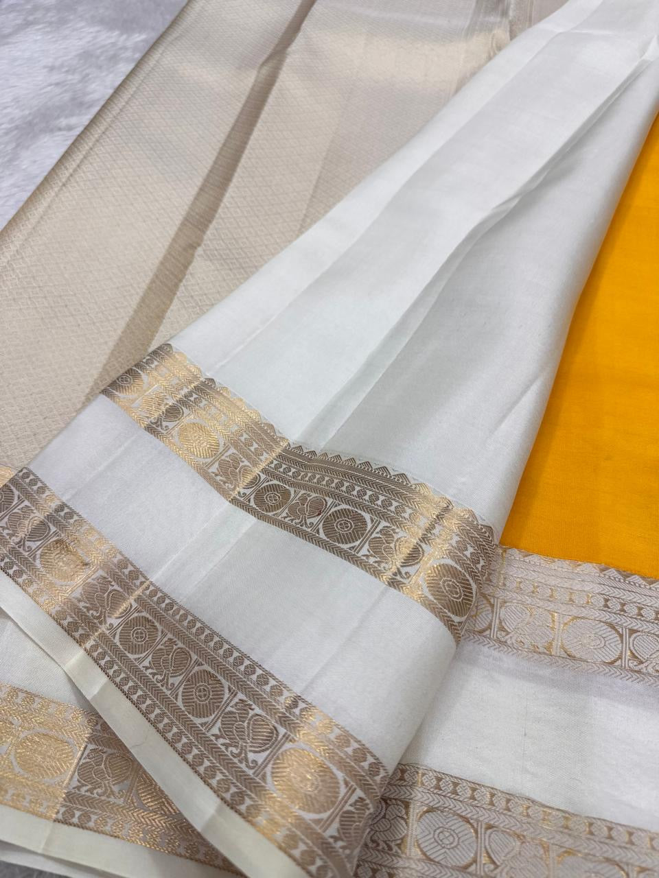 Gold zari kattam checks and Kamalam buttas on marigold Kanjivaram saree