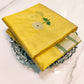 Full view of yellow Pattu Silk Chanderi saree with silver floral motifs and fine green striped metallic borders