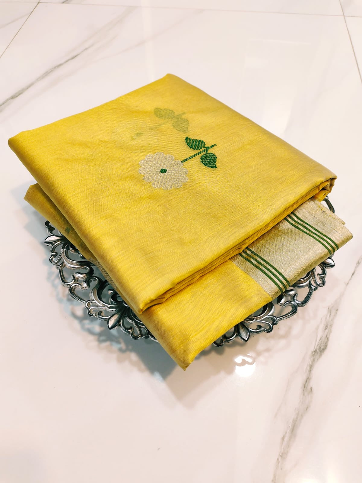 Full view of yellow Pattu Silk Chanderi saree with silver floral motifs and fine green striped metallic borders