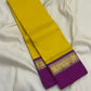 Pure Kanchipuram silk saree folded lengthwise showing yellow body and purple border with gold zari woven band